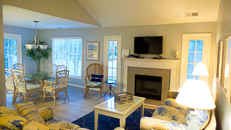 living room with fireplace and tv in our HHI Rentals